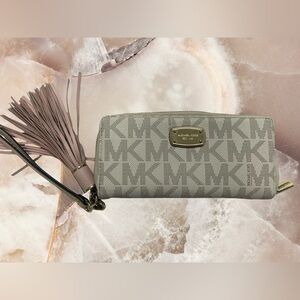 Michael Kors, leather wristlet wallet with tassel condition used